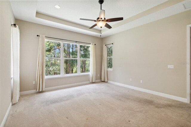 207 Spalding Way, Deland, FL 32724 - spare room featuring light colored carpet, a raised ceiling, and ceiling fan