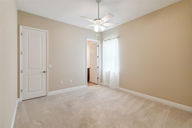207 Spalding Way, Deland, FL 32724 - unfurnished bedroom featuring light colored carpet, ensuite bathroom, and a ceiling fan
