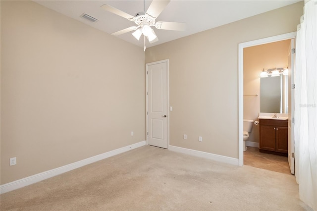 207 Spalding Way, Deland, FL 32724 - unfurnished bedroom featuring light colored carpet, connected bathroom, and ceiling fan