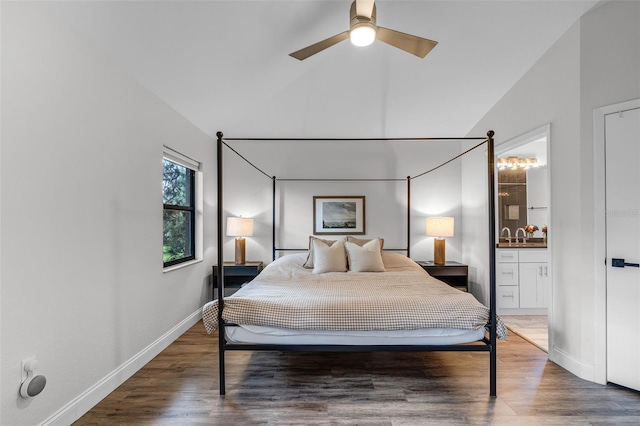 7742 Sugar Bend Dr Unit 7742, Orlando, FL 32819 - bedroom featuring lofted ceiling, wood finished floors, and connected bathroom