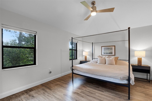 7742 Sugar Bend Dr Unit 7742, Orlando, FL 32819 - bedroom featuring multiple windows, wood finished floors, lofted ceiling, and ceiling fan