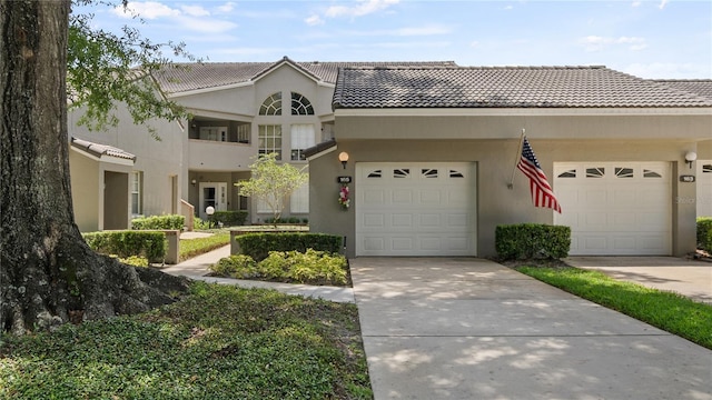 165 Durham Pl Unit 165, Longwood, FL 32779 - view of front of home with a tiled roof, stucco siding, and concrete driveway