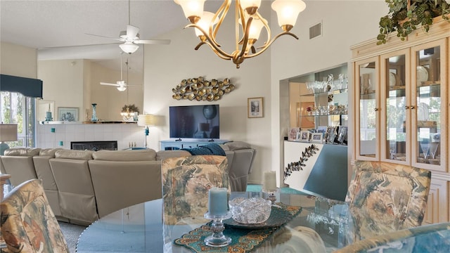 165 Durham Pl Unit 165, Longwood, FL 32779 - dining room featuring ceiling fan, high vaulted ceiling, a chandelier, and a tiled fireplace