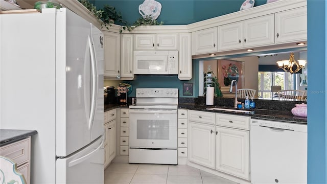 165 Durham Pl Unit 165, Longwood, FL 32779 - kitchen featuring white appliances, light tile patterned floors, a chandelier, white cabinetry, and dark stone counters