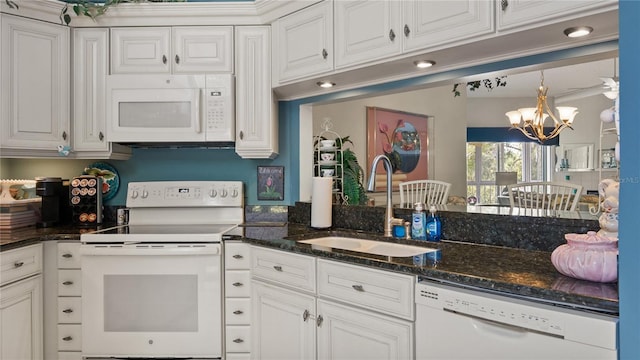 165 Durham Pl Unit 165, Longwood, FL 32779 - kitchen featuring white appliances, white cabinets, a chandelier, dark stone countertops, and hanging light fixtures