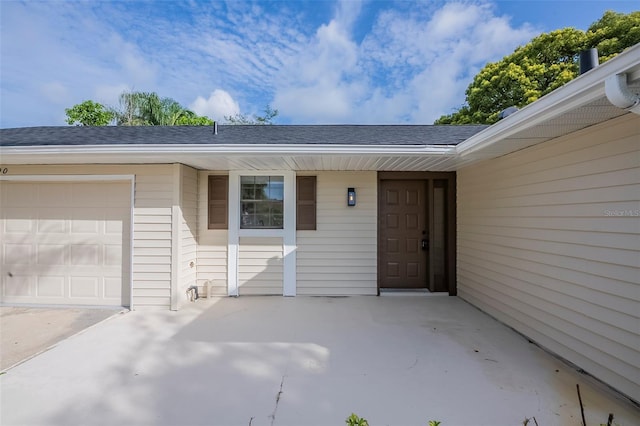4800 Reginald Rd, Orlando, FL 32829 - property entrance featuring an attached garage and a shingled roof