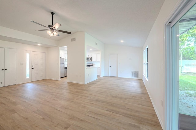 4800 Reginald Rd, Orlando, FL 32829 - unfurnished living room featuring lofted ceiling, a ceiling fan, light wood-type flooring, and recessed lighting
