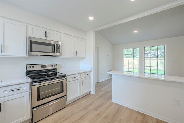 4800 Reginald Rd, Orlando, FL 32829 - kitchen with appliances with stainless steel finishes, white cabinets, light countertops, light wood-type flooring, and recessed lighting