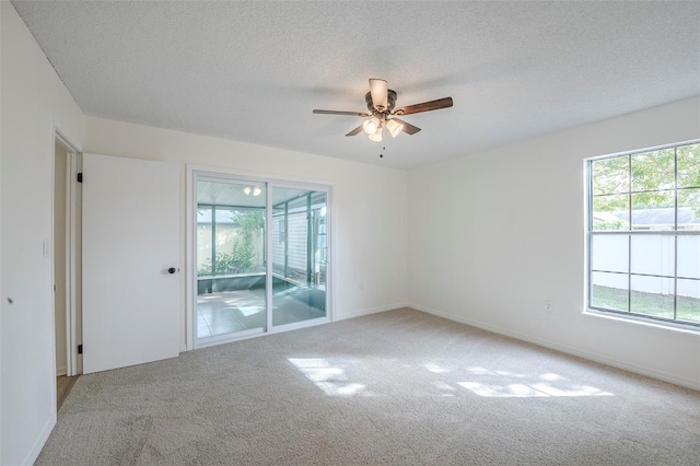 4800 Reginald Rd, Orlando, FL 32829 - empty room with light carpet, a ceiling fan, and a textured ceiling