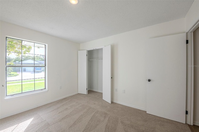 4800 Reginald Rd, Orlando, FL 32829 - unfurnished bedroom with light carpet, a textured ceiling, and a closet