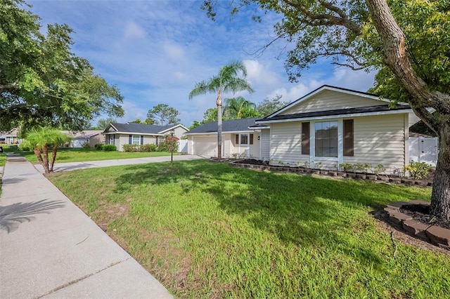 4800 Reginald Rd, Orlando, FL 32829 - single story home with concrete driveway, an attached garage, and a front lawn