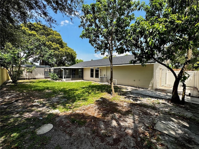 4800 Reginald Rd, Orlando, FL 32829 - rear view of property with a sunroom and a fenced backyard