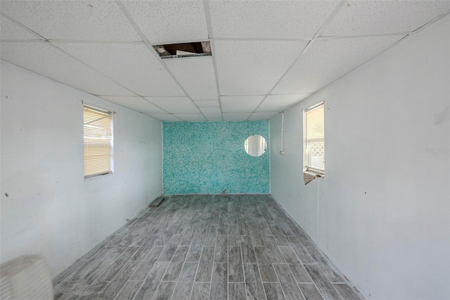 4800 Reginald Rd, Orlando, FL 32829 - basement featuring wood finished floors, a paneled ceiling, and plenty of natural light
