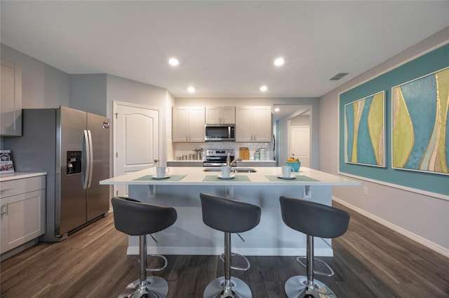 1902 Walnut Creek Dr, Kissimmee, FL 34744 - kitchen with stainless steel appliances, dark wood-style flooring, light countertops, and recessed lighting