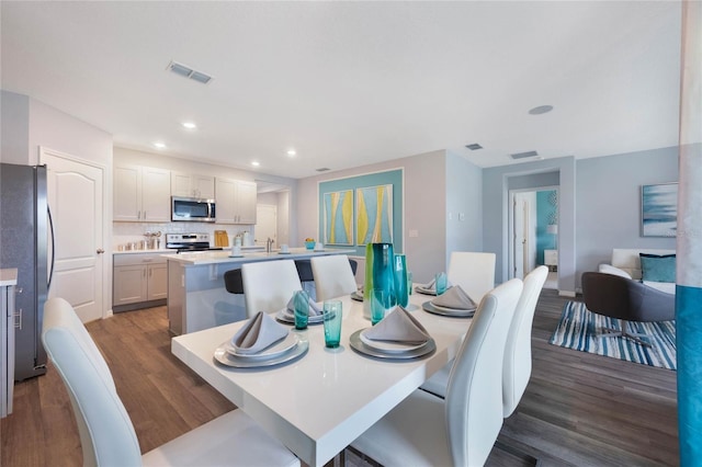 1902 Walnut Creek Dr, Kissimmee, FL 34744 - dining room featuring dark wood-style floors and recessed lighting