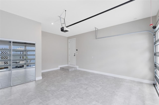 8290 Nemours Pkwy, Orlando, FL 32827 - garage with a garage door opener and baseboards