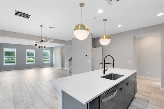 8290 Nemours Pkwy, Orlando, FL 32827 - kitchen with dishwasher, light countertops, hanging light fixtures, a kitchen island with sink, and recessed lighting