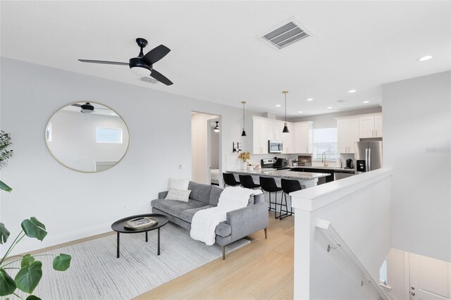 8290 Nemours Pkwy, Orlando, FL 32827 - living area featuring a ceiling fan, recessed lighting, and light wood-style floors