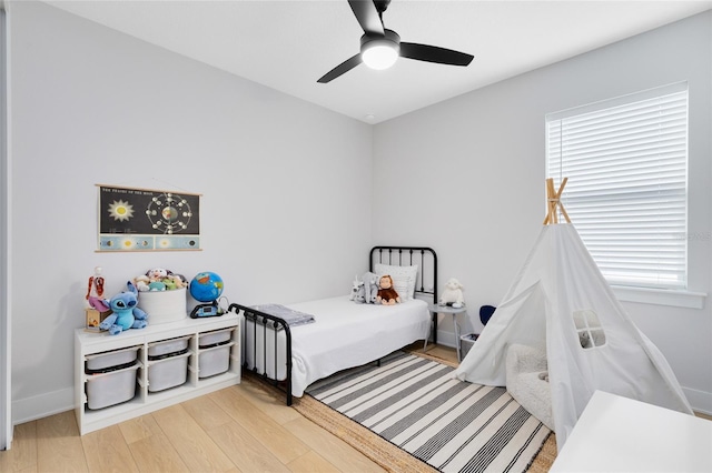 8290 Nemours Pkwy, Orlando, FL 32827 - bedroom with light wood-type flooring, multiple windows, and ceiling fan