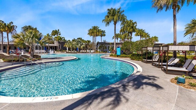 8290 Nemours Pkwy, Orlando, FL 32827 - community pool featuring a patio area