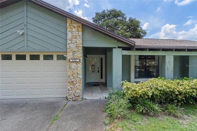 3220 Cardigan Ct, Orlando, FL 32812 - doorway to property with concrete driveway, roof with shingles, stone siding, and stucco siding
