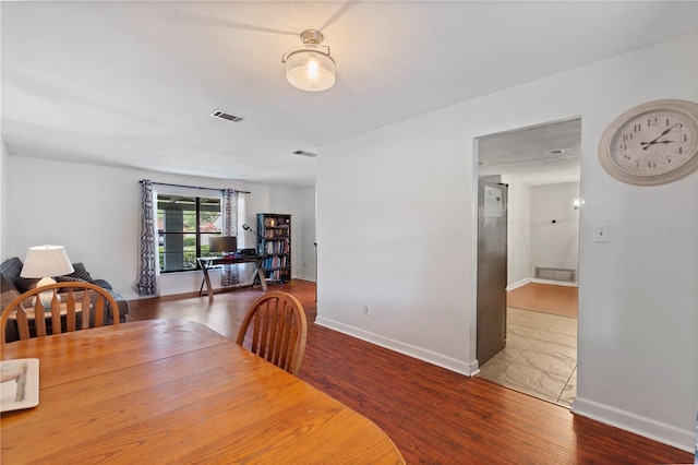 3220 Cardigan Ct, Orlando, FL 32812 - dining space with wood finished floors and baseboards