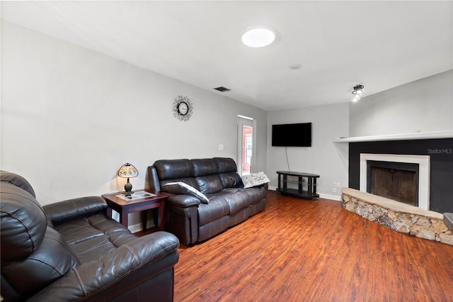 3220 Cardigan Ct, Orlando, FL 32812 - living area featuring wood finished floors and a stone fireplace