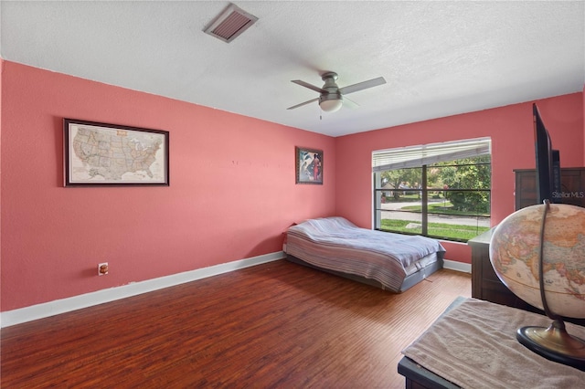 3220 Cardigan Ct, Orlando, FL 32812 - bedroom with wood finished floors, a textured ceiling, and a ceiling fan
