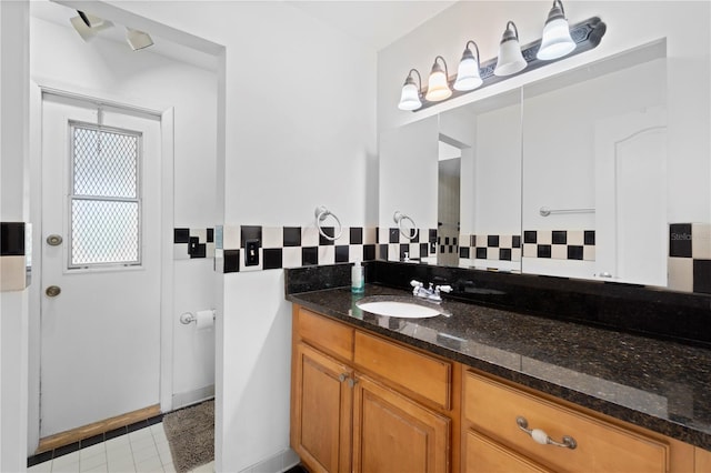 3220 Cardigan Ct, Orlando, FL 32812 - bathroom with vanity, backsplash, and tile patterned flooring