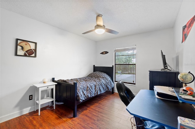 3220 Cardigan Ct, Orlando, FL 32812 - bedroom featuring wood finished floors, a textured ceiling, a ceiling fan, and an office area