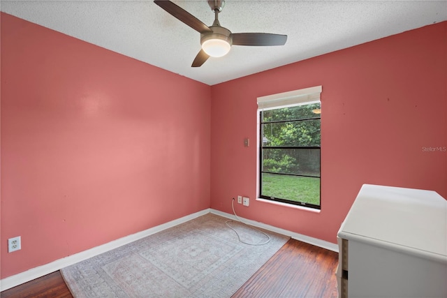 3220 Cardigan Ct, Orlando, FL 32812 - empty room with dark wood-style flooring, ceiling fan, and a textured ceiling