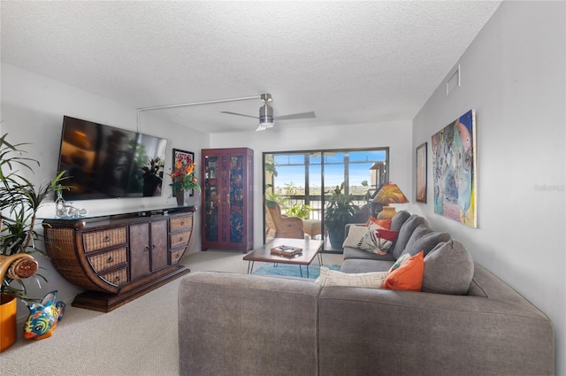 9860 62nd Ter N Unit 1047, Saint Petersburg, FL 33708 - living area with carpet flooring, a ceiling fan, and a textured ceiling
