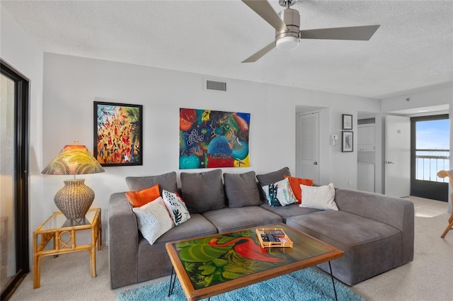 9860 62nd Ter N Unit 1047, Saint Petersburg, FL 33708 - living area featuring carpet flooring, a textured ceiling, and a ceiling fan