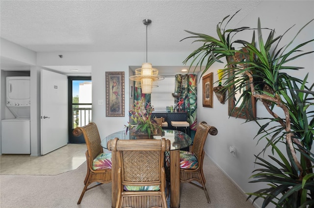 9860 62nd Ter N Unit 1047, Saint Petersburg, FL 33708 - dining room with stacked washer / drying machine, light carpet, and a textured ceiling