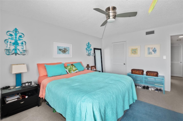 9860 62nd Ter N Unit 1047, Saint Petersburg, FL 33708 - carpeted bedroom with a textured ceiling, a closet, and a ceiling fan