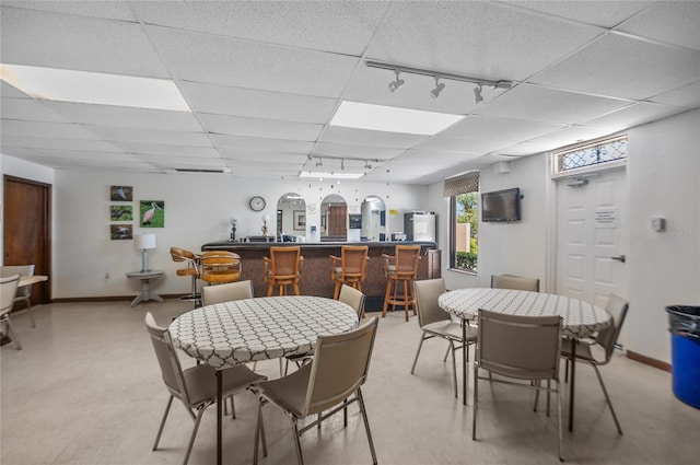 9860 62nd Ter N Unit 1047, Saint Petersburg, FL 33708 - dining room featuring rail lighting, a paneled ceiling, and a community bar