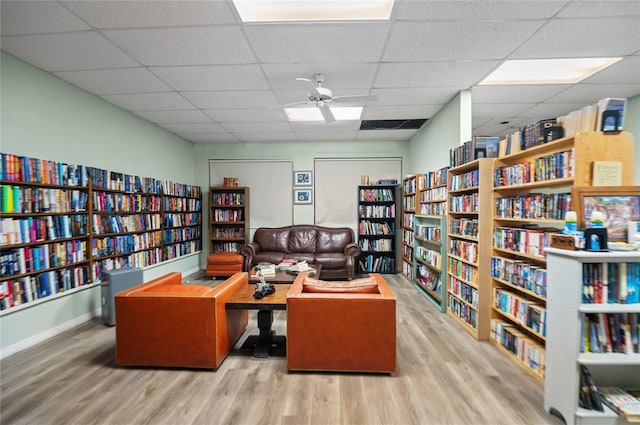 9860 62nd Ter N Unit 1047, Saint Petersburg, FL 33708 - office featuring wall of books, wood finished floors, a drop ceiling, and a ceiling fan