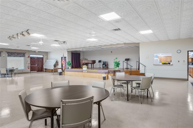 9860 62nd Ter N Unit 1047, Saint Petersburg, FL 33708 - dining room with baseboards and track lighting