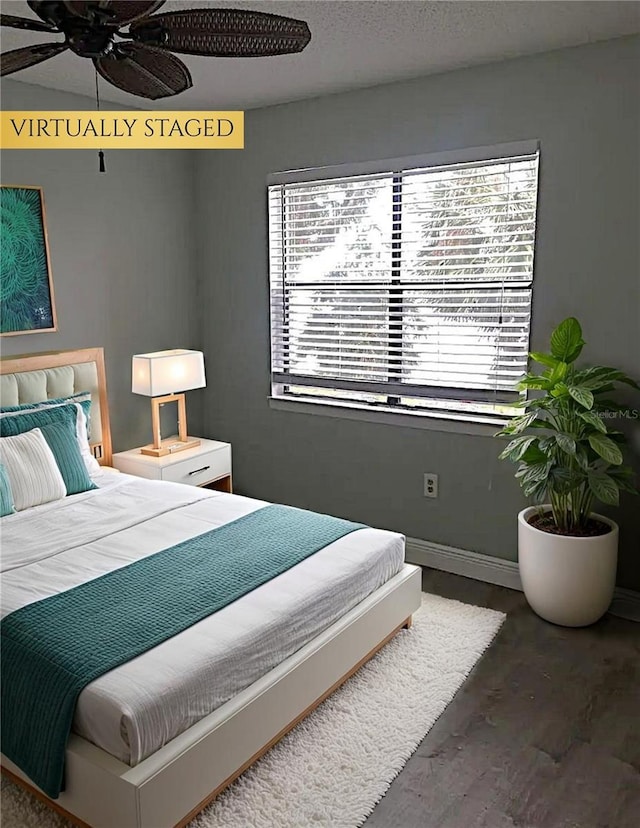 225 S Tropical Trl Unit 402, Merritt Island, FL 32952 - bedroom featuring wood finished floors and a ceiling fan