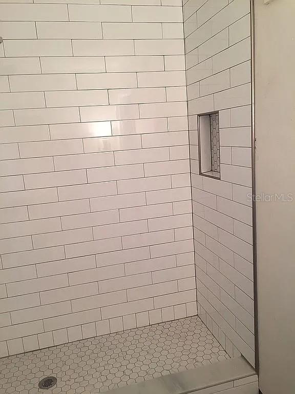 225 S Tropical Trl Unit 402, Merritt Island, FL 32952 - full bathroom with a tile shower
