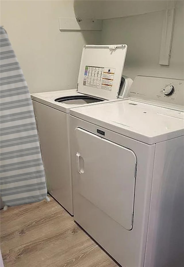 225 S Tropical Trl Unit 402, Merritt Island, FL 32952 - laundry area featuring light wood finished floors and washer and clothes dryer