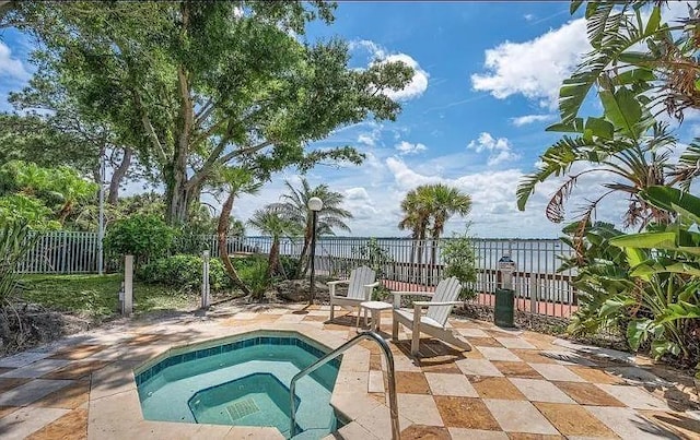 225 S Tropical Trl Unit 402, Merritt Island, FL 32952 - view of pool featuring a community hot tub, a fenced backyard, a patio, and a swimming pool