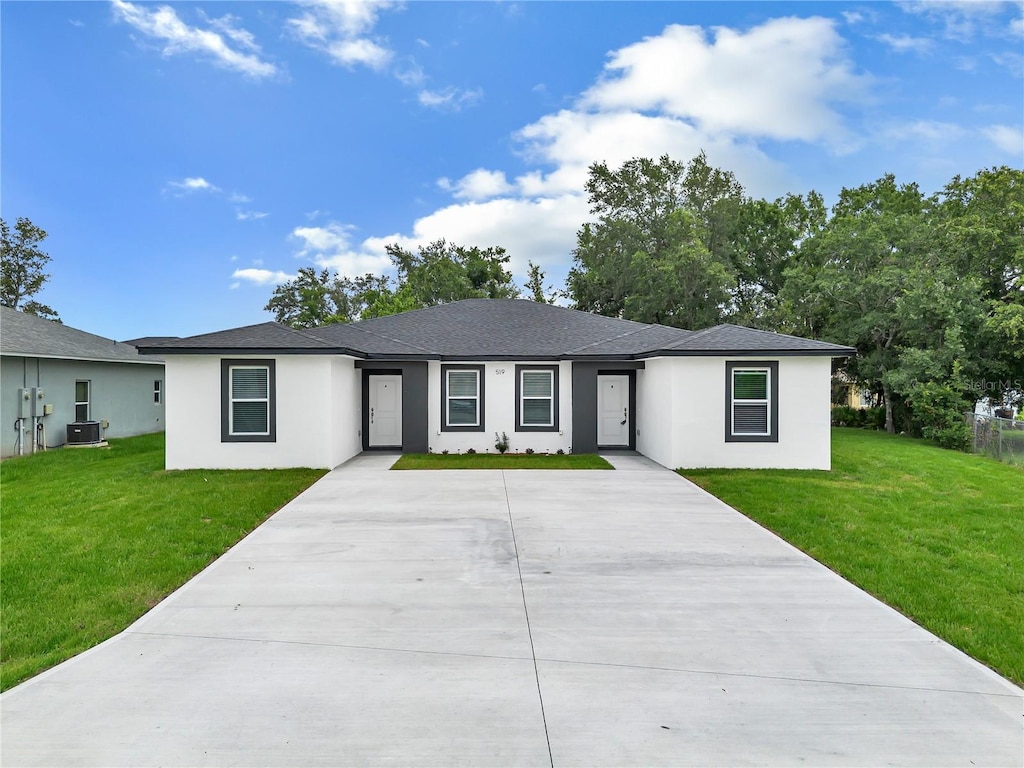 519 Blackbird Ln # A & B, Kissimmee, FL 34759 - single story home with stucco siding, a front yard, and driveway
