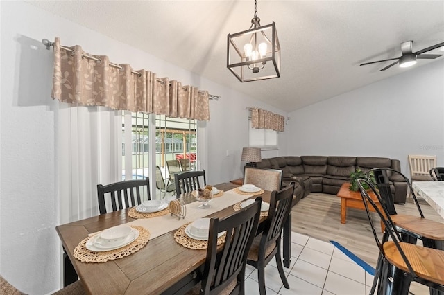 7764 Indian Ridge Trl N, Kissimmee, FL 34747 - dining room featuring lofted ceiling, light tile patterned flooring, a chandelier, and a ceiling fan
