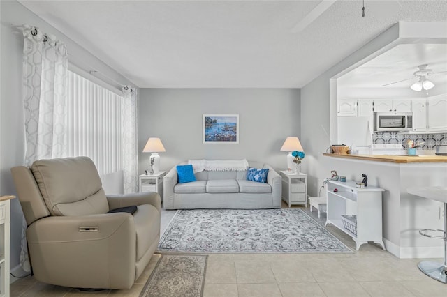 11923 Boynton Ln Unit B, New Port Richey, FL 34654 - living area featuring a ceiling fan and light tile patterned flooring