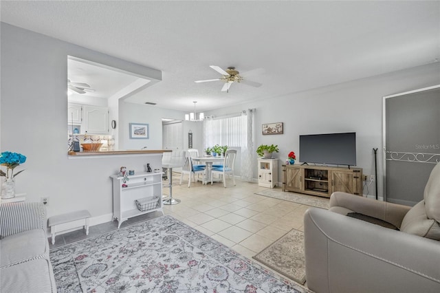 11923 Boynton Ln Unit B, New Port Richey, FL 34654 - living room with a ceiling fan, light tile patterned floors, and a chandelier