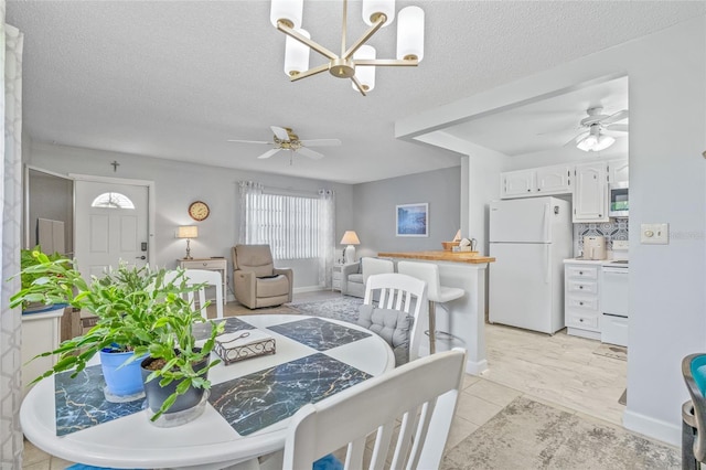 11923 Boynton Ln Unit B, New Port Richey, FL 34654 - dining room with ceiling fan, a chandelier, and a textured ceiling