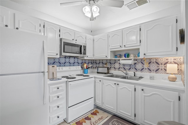 11923 Boynton Ln Unit B, New Port Richey, FL 34654 - kitchen featuring white appliances, a ceiling fan, decorative backsplash, light countertops, and white cabinetry