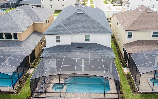 9071 Sunshine Ridge Loop, Kissimmee, FL 34747 - view of swimming pool featuring a residential view, a lanai, a patio area, and a pool with connected hot tub