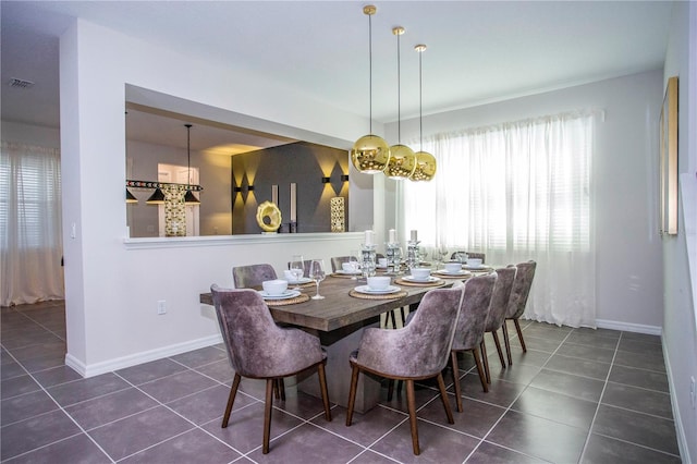 9071 Sunshine Ridge Loop, Kissimmee, FL 34747 - dining area with dark tile patterned floors and baseboards